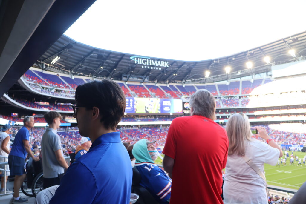 A young attendee watching the field from an accessible viewing area