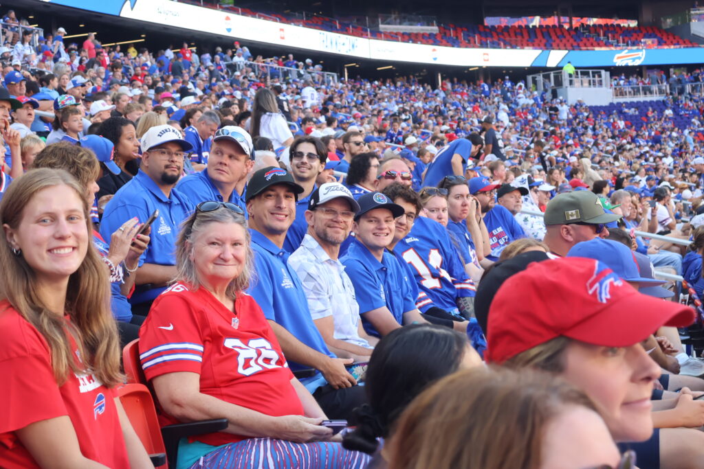 Attendees seated in a packed section of Buffalo Bills fans
