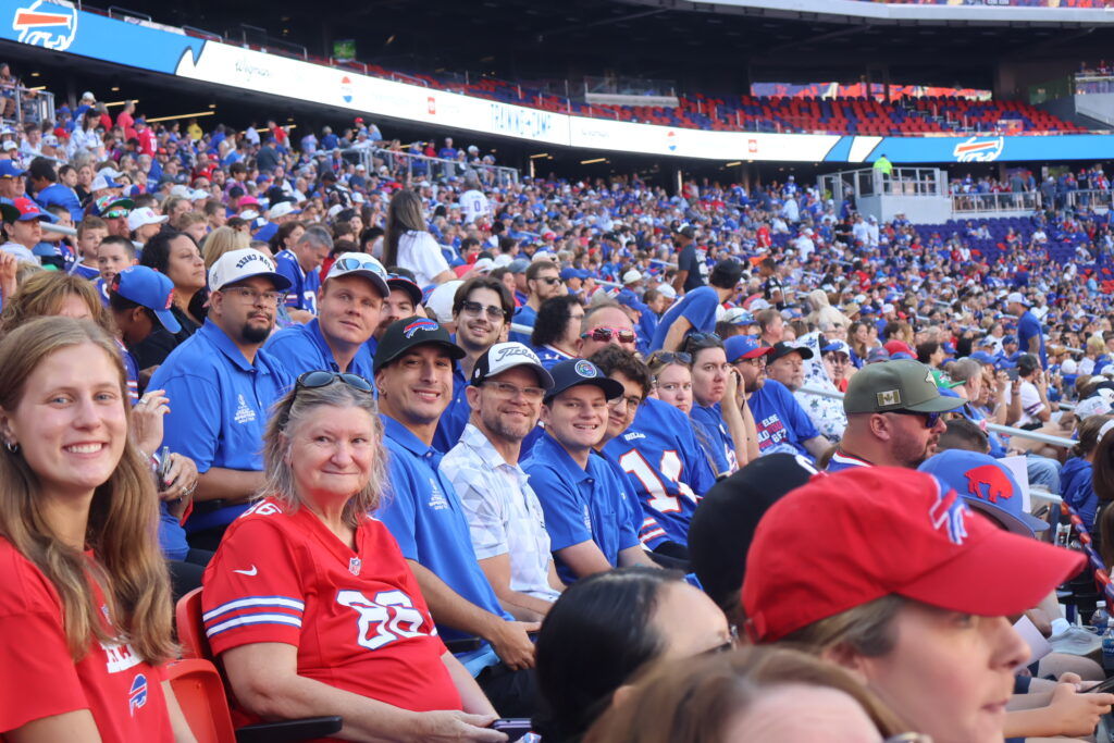 A row of attendees watching from the stands