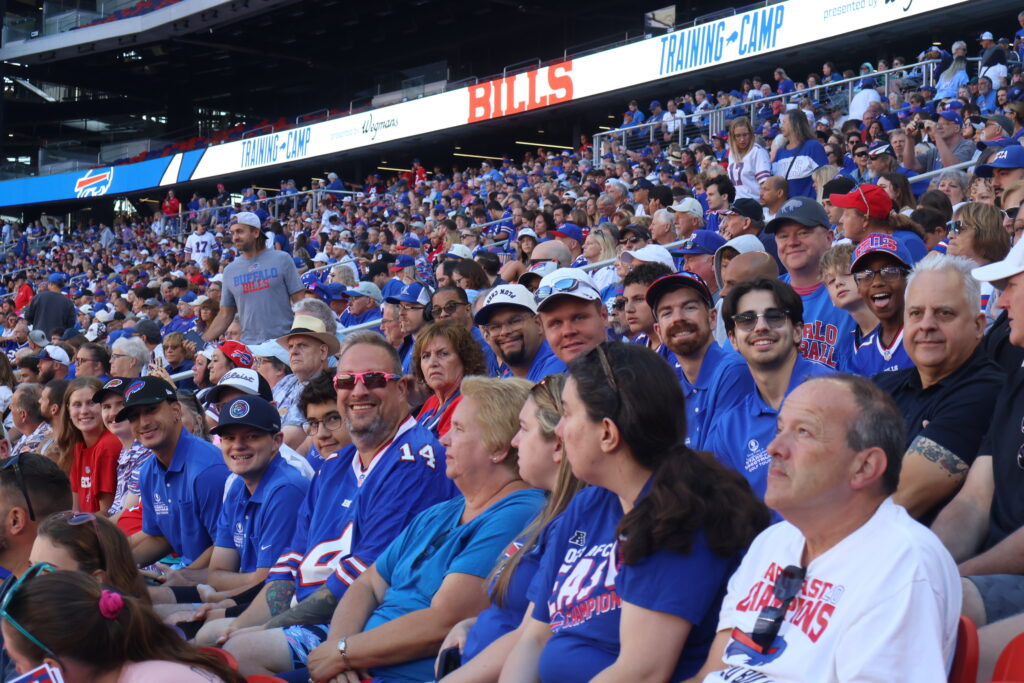 A packed section of fans beneath the Bills Training Camp banner