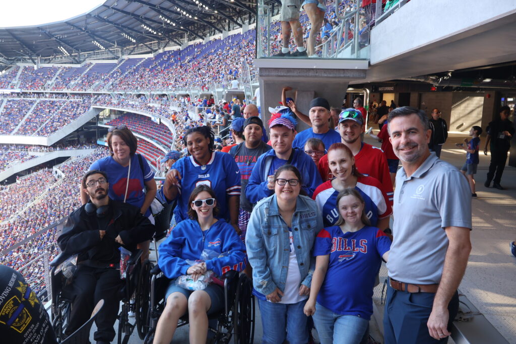 A group of attendees, one using a wheelchair, at an accessible viewing platform