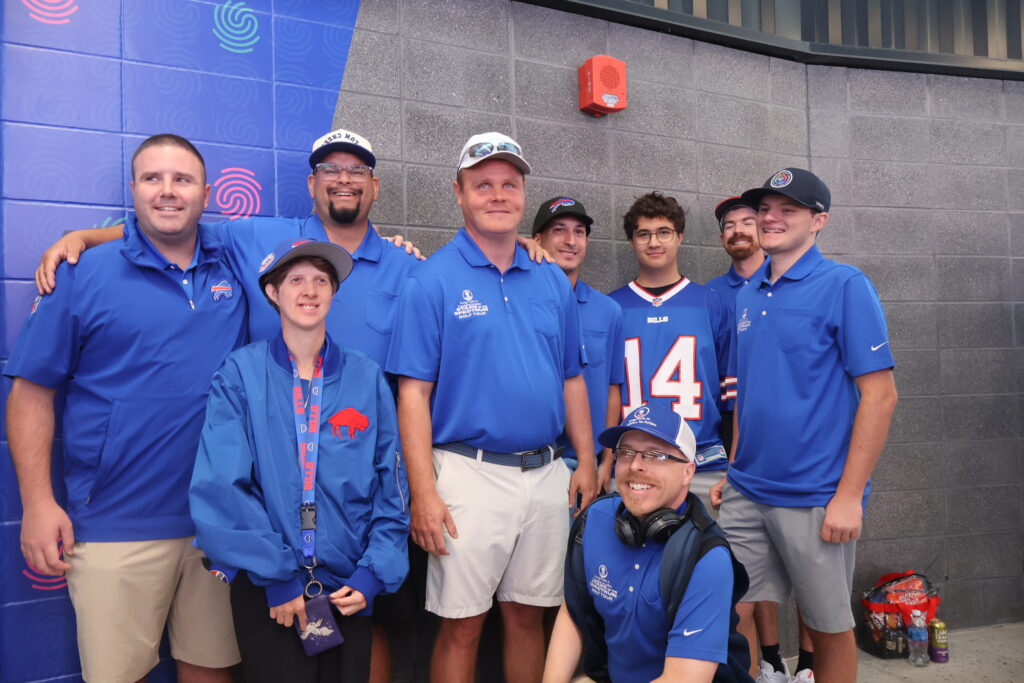 A group of attendees in Foundation polo shirts outside the sensory room