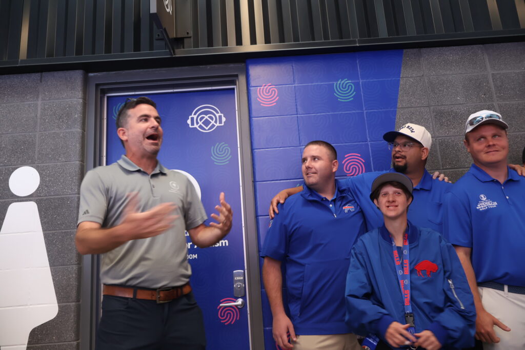 A host speaking to attendees at the sensory room entrance
