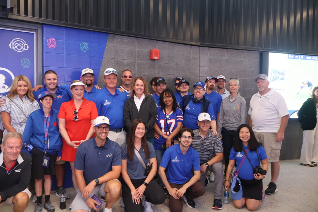 A group photograph of attendees at the sensory room opening