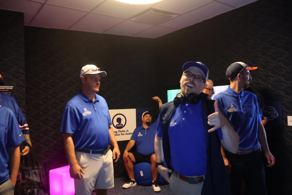 A group in Foundation polo shirts laughing together inside the sensory room