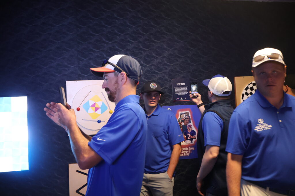 Visitors gathered around the sensory room's light and texture panels