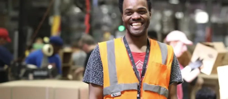 A BCI Packaging team member in a high-visibility vest at work in the Boone Center warehouse