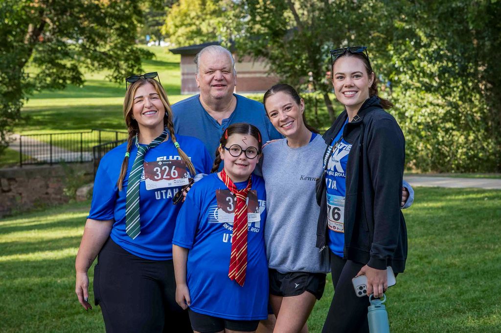 A family of Flutie 5K participants posing together, one of them in costume