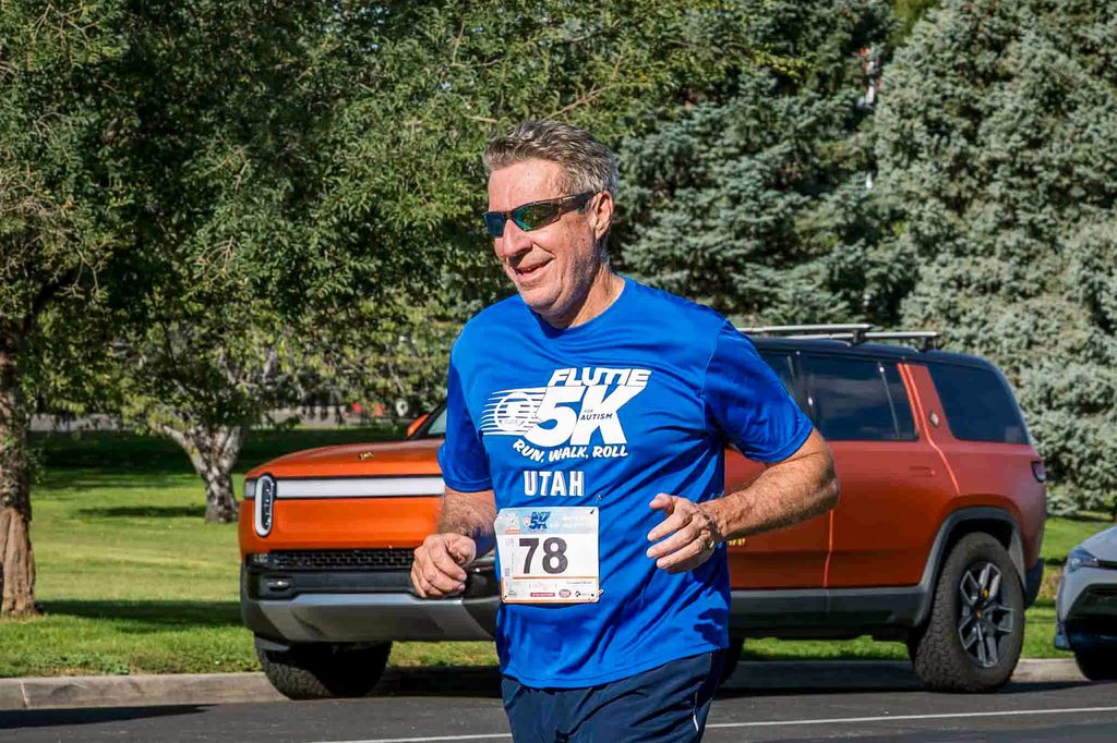 A runner in a Flutie 5K Utah shirt out on the course