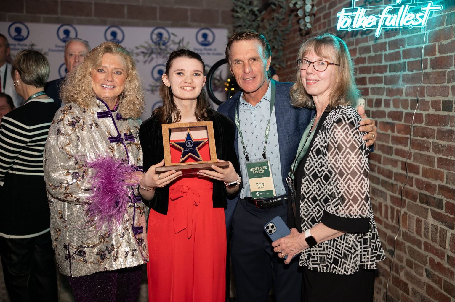 Doug and Laurie Flutie with an award recipient at the Foundation’s Rooftop Benefit for Autism